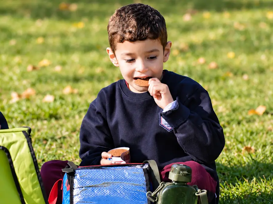 A student with his packed lunch in the schoolyard